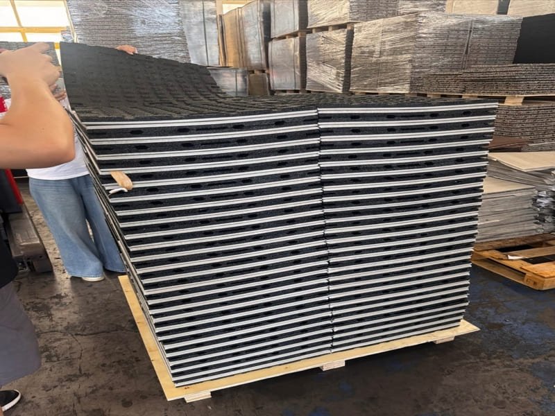 A flooring installer using a 10-foot straightedge to check the flatness of a concrete subfloor